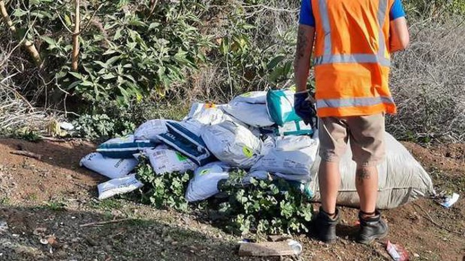 A Mangere local who went on her morning walk was shocked to find a pile of courier packages strewn across the grass. (Photo / Shane M Twitter)