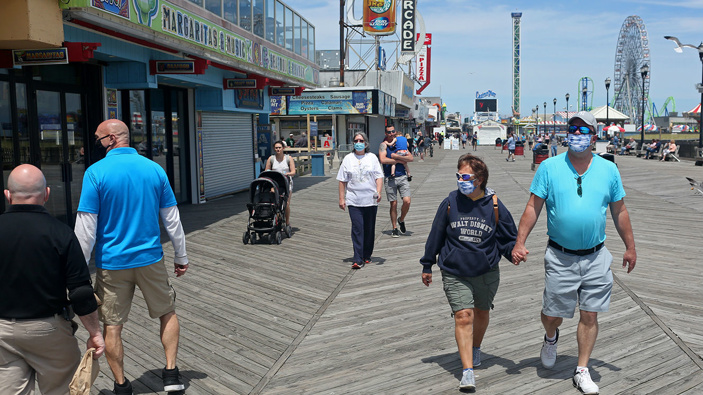 People traverse the Seaside Heights boardwalk in New Jersey as the state begins to reopen beaches and boardwalks. (Photo / Getty0