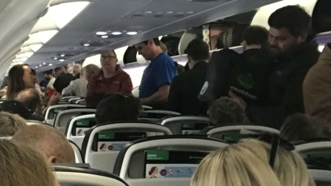 Passengers were quick to break social distancing rules after landing, the man said. Photo / Supplied