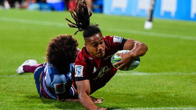 Leicester Faingaanuku of the Crusaders scores a try in the tackle of Henry Speight of the Reds. (Photo / Photosport)