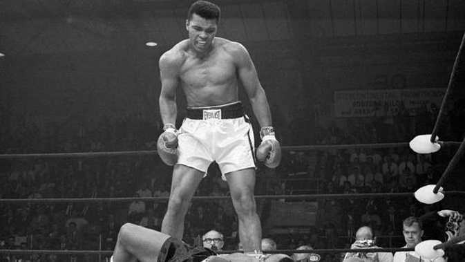Muhammad Ali stands over Sonny Liston and taunts him to get up during their title fight in 1965. (Photo / Getty)