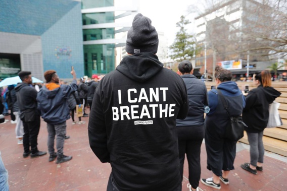 Protesters at Aotea Square in Auckland wear clothing bearing the cry for help of George Floyd. Photo / Dean Purcell