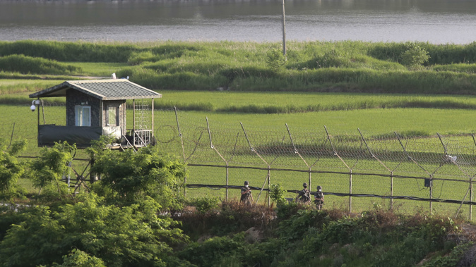 South Korean army soldiers patrol along the barbed-wire fence in Paju, near the border with North Korea. (Photo / AP)
