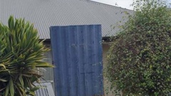 A Christchurch social housing tenant claims her neighbours built this shield after two shootings at the property.