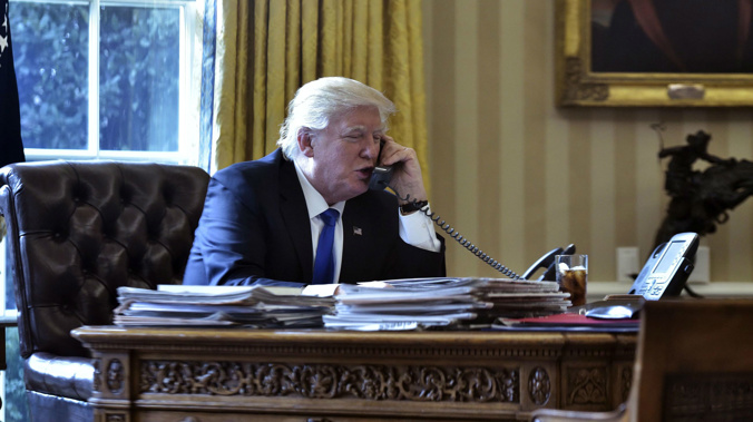 US President Donald Trump speaks on the phone with Russia's President Vladimir Putin from the Oval Office of the White House on January 28, 2017, in Washington, DC. (Photo / Getty)