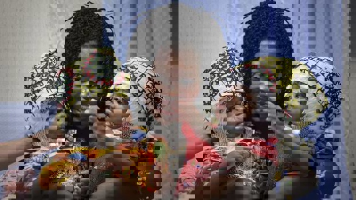 Ermine Nzotto holds her twins Ervina and Prefina Bangalo, at the Vatican pediatric hospital, in Rome, Italy. Photo / AP