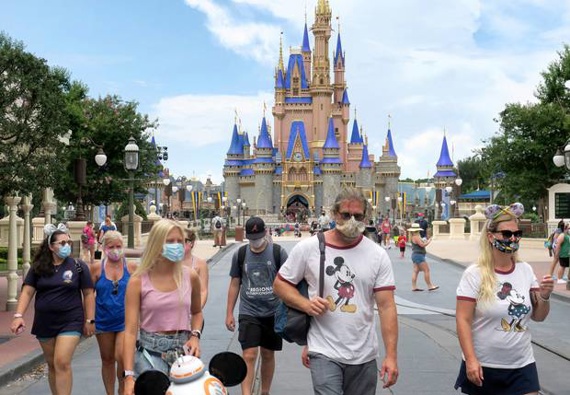 Guests wear masks as required to attend the official reopening day of the Magic Kingdom at Walt Disney World in Florida. Photo / AP