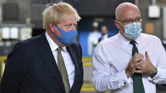 Britain's Prime Minister Boris Johnson, wearing a face mask, talks with CEO London Ambulance Service Garrett Emmerson. (Photo / AP)
