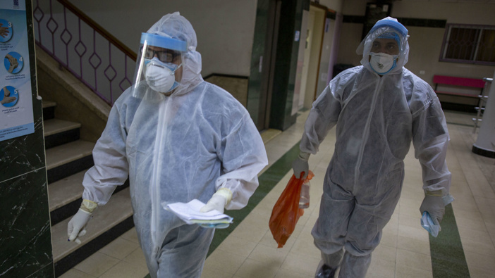 Palestinian medics wear protective suits as they take part in a simulation of possible coronavirus infections in Gaza City. (Photo / AP)