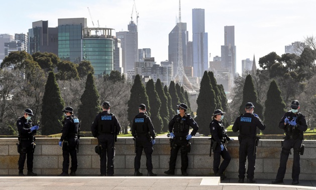 Police patrol The Shrine of Remembrance enforcing the wearing of face masks in Melbourne on July 31, 2020.