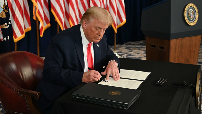 President Donald Trump signs executive orders extending coronavirus economic relief. (Photo / AFP via CNN)