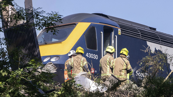 Emergency services attend the scene of a derailed train in Stonehaven, Scotland. (Photo / AP)