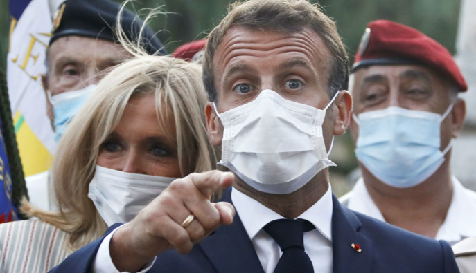 French President Emmanuel Macron and his wife Brigitte Macron wearing face masks. (Photo / AP)