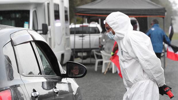 A member of Tai Tokerau Border Control talks to a motorist at the Waiomio checkpoint during the March lockdown. Photo / John Stone