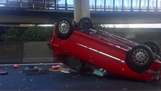 A vehicle flipped in the crash near Spaghetti Junction just after 9am. However, FENZ have confirmed the occupants only suffered minor injuries. Photo / William Terite