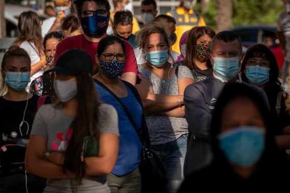 People wearing face masks wait their turn to be called for a PCR test for the Covid-19 in Barcelona, Spain. Photo / AP