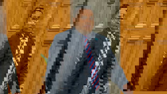 Immigration Minister Kris Faafoi on his way into the House for Question Time, Parliament. (Photo / Mark Mitchell)