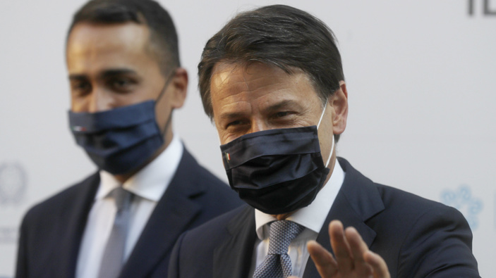 Italian Premier Giuseppe Conte, right, and Foreign Minister Luigi Di Maio wave to journalists. (Photo / AP)
