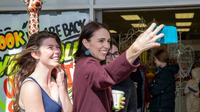 Prime Minister Jacinda Ardern posing for selfies with fans during her walkabout in Palmerston North. Photo / Mark Mitchell