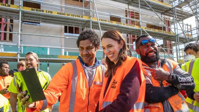 Prime Minister Jacinda Ardern poses for selfies with tradesmen at Isles Construction in Palmerston North last week. Judith Collins claims Ardern is breaking her own rules. Photo / Mark Mitchell