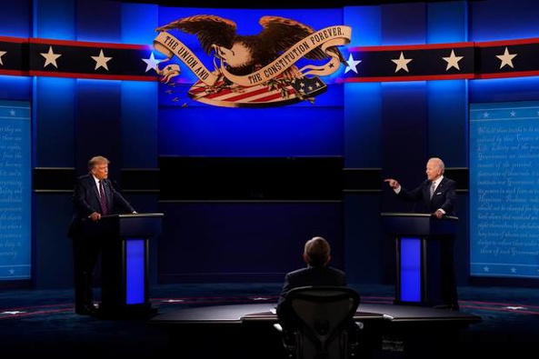 Donald Trump, left, and Joe Biden, right, during the first presidential debate with moderator Chris Wallace, centre. (Photo / AP)