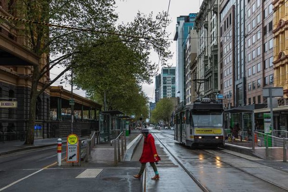 A woman crosses the usually busy Flinders Street / Elizabeth Street intersection on September 25 in Melbourne. Photo / Getty Images