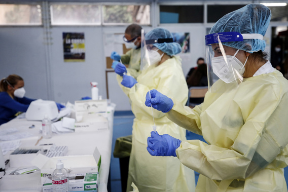 Medical staff hold swabs for rapid Covid-19 tests at a high school in Rome, Sept. 28.