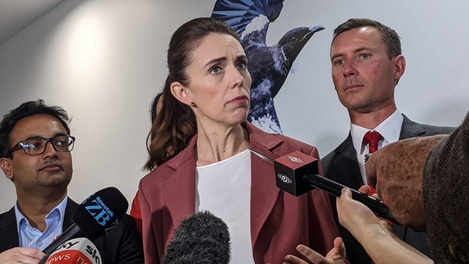 Prime Minister Jacinda Ardern talks to media flanked by Labour party candidates Dr Gaurav Sharma for Hamilton West (left) and Jamie Strange for Hamilton East. (Photo / Amelia Wade)