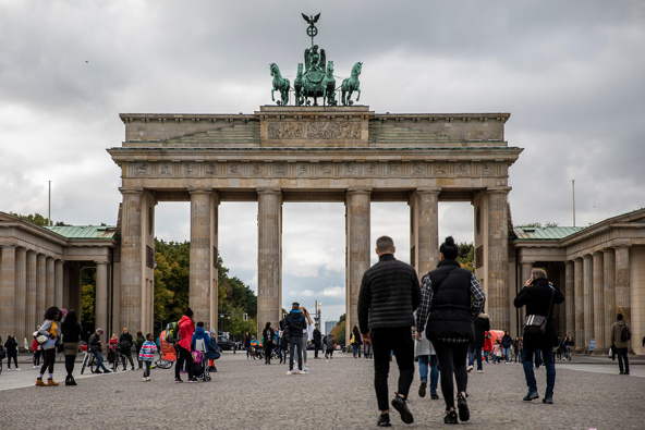 Tourists walk at the Brandenburg Gate in Berlin, as the city's businesses fight curfew orders in the courts. (Photo / Getty)