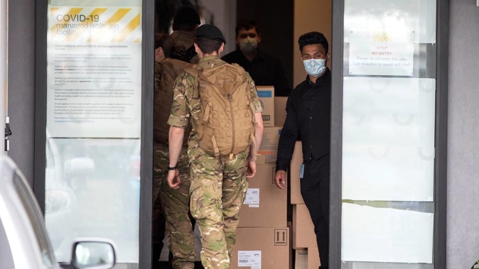 Military personnel enter the Sudima Hotel in Christchurch. Photo / NZH
