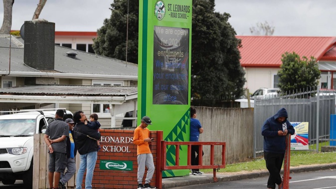Parents wait to pick up their children at St Leonards Rd School. Photo / Dean Purcell