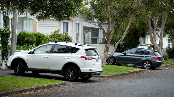 Cars parked over footpaths in central Auckland. Photo / Dean Purcell.