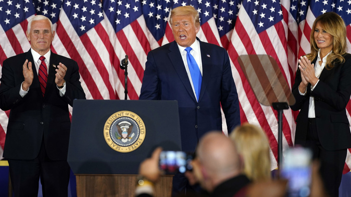 Vice President Mike Pence and first lady Melania Trump applaud after President Donald Trump spoke in the East Room of the White House. (Photo / AP)