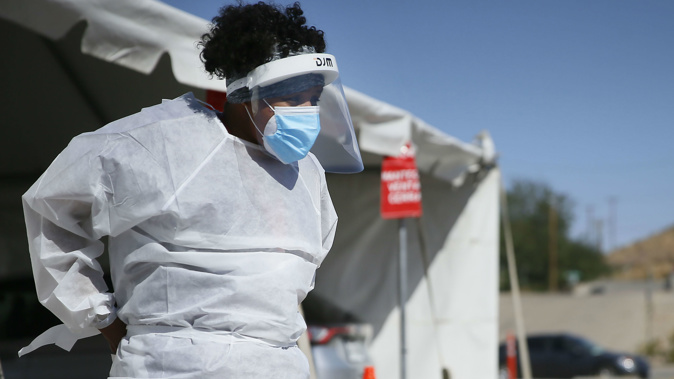 A medical worker stands at a COVID-19 state drive-thru testing site in El Paso, Texas. (Photo / AP)