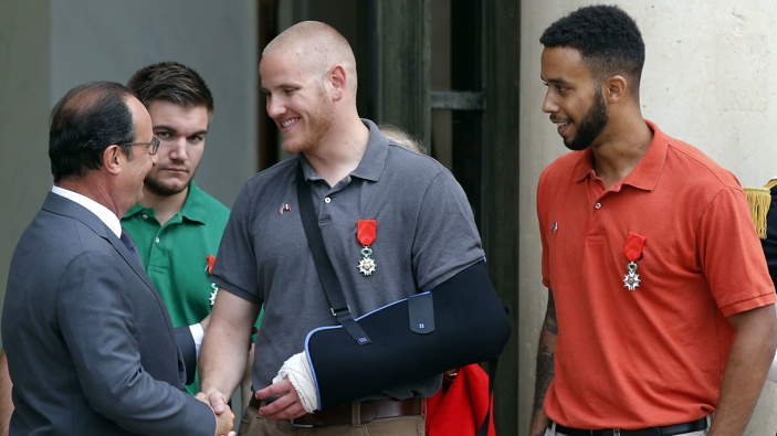 In this Aug. 24, 2015 file photo, French President Francois Hollande bids farewell to U.S. Airman Spencer Stone as U.S. National Guardsman Alek Skarlatos of Roseburg, Ore., second from left, and Anthony Sadler, right, after Hollande awarded them the French Legion of Honor at the Elysee Palace in Paris. 