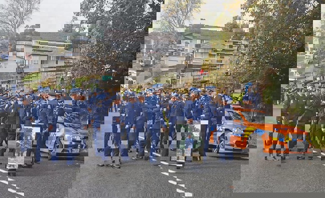 The family of slain policeman Matthew Hunt and colleagues marched to remember him near where he was shot dead. Photo / NZ Herald