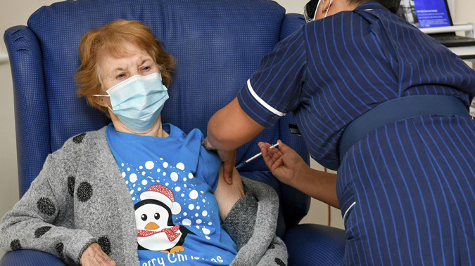 90 year old Margaret Keenan, the first patient in the UK to receive the Pfizer-BioNTech COVID-19 vaccine, administered by nurse May Parsons at University Hospital, Coventry,