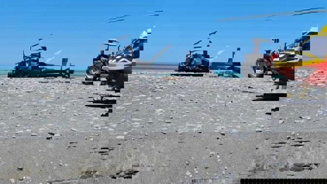 The crash scene of a Eurcopter helicopter from Glenloch Helicopters lies on the beach at the mouth of the Kekerengu River, north of Kaikoura. Photo / Supplied