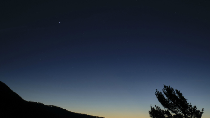 In this Sunday, Dec. 13, 2020 photo made available by NASA, Saturn, top, and Jupiter, below, are seen after sunset from Shenandoah National Park in Luray, Va.  (Photo / via AP)