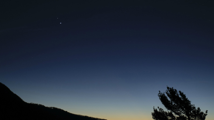 In this Sunday, Dec. 13, 2020 photo made available by NASA, Saturn, top, and Jupiter, below, are seen after sunset from Shenandoah National Park in Luray, Va. (Photo / via AP)