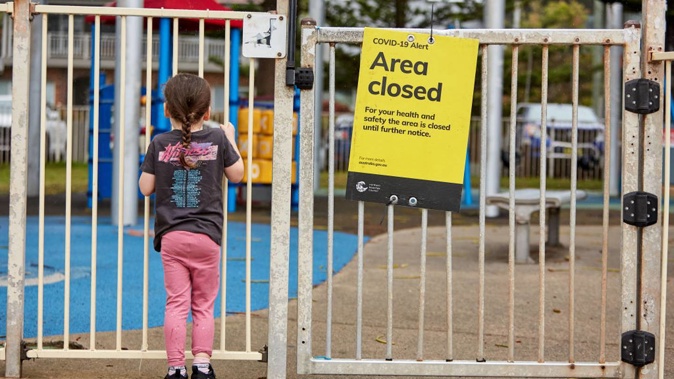 A child is seen locked out of a closed park at Dee Why beachfront in Sydney as parts of the city goes into lockdown. Photo / Getty Images