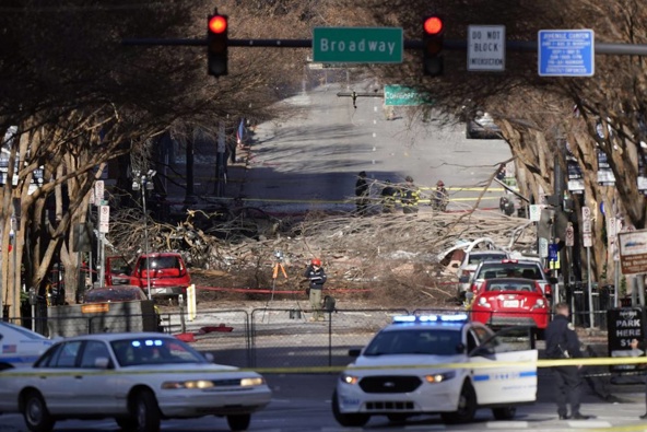 Investigators continue to examine the site of the explosion. Photo / AP