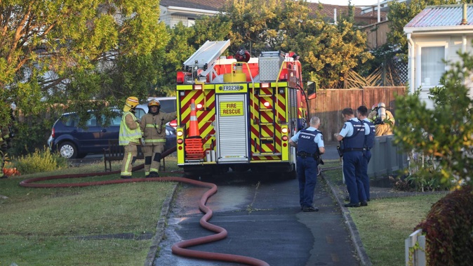 Fire services are at the scene of a house fire on Mulgan St, New Windsor, Auckland. Photo / Hayden Woodward