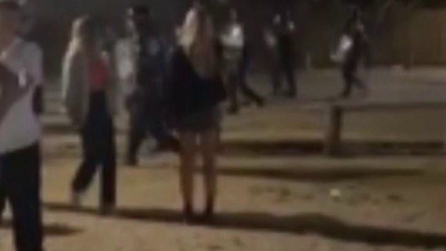 Police have been filmed kicking a rioter as chaos reigned at NY celebrations. Video / Supplied