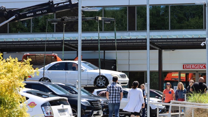 Police remove a white Mercedes connected with a homicide from outside the Christchurch Hospital Emergency Department. Photo / Kurt Bayer