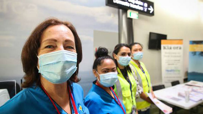 Health officials at Auckland International Airport. (Photo / NZ Herald)