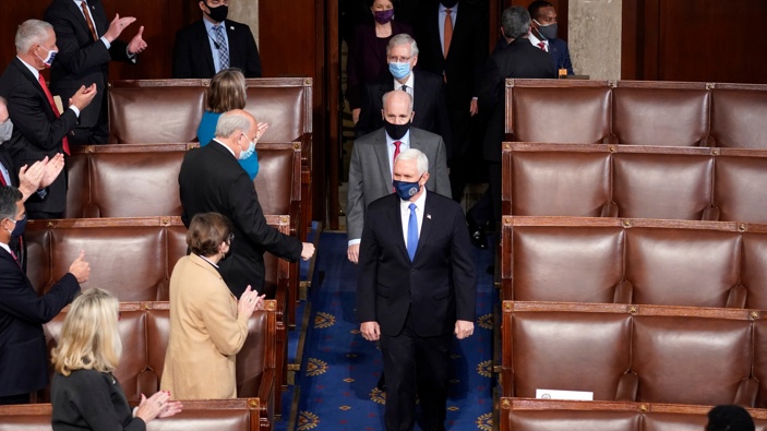 Vice President Mike Pence arrives with members of the Senate to officiate as a joint session of the House and Senate convenes to count the electoral votes cast in November's election. (Photo / AP)