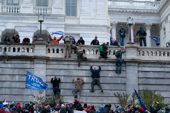 Supporters of President Donald Trump climb the west wall of the the Capitol on Jan. 6 in Washington.