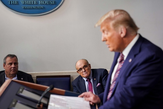 Chris Christie and Rudy Giuliani listen to Donald Trump during a conference. Photo / Getty Images