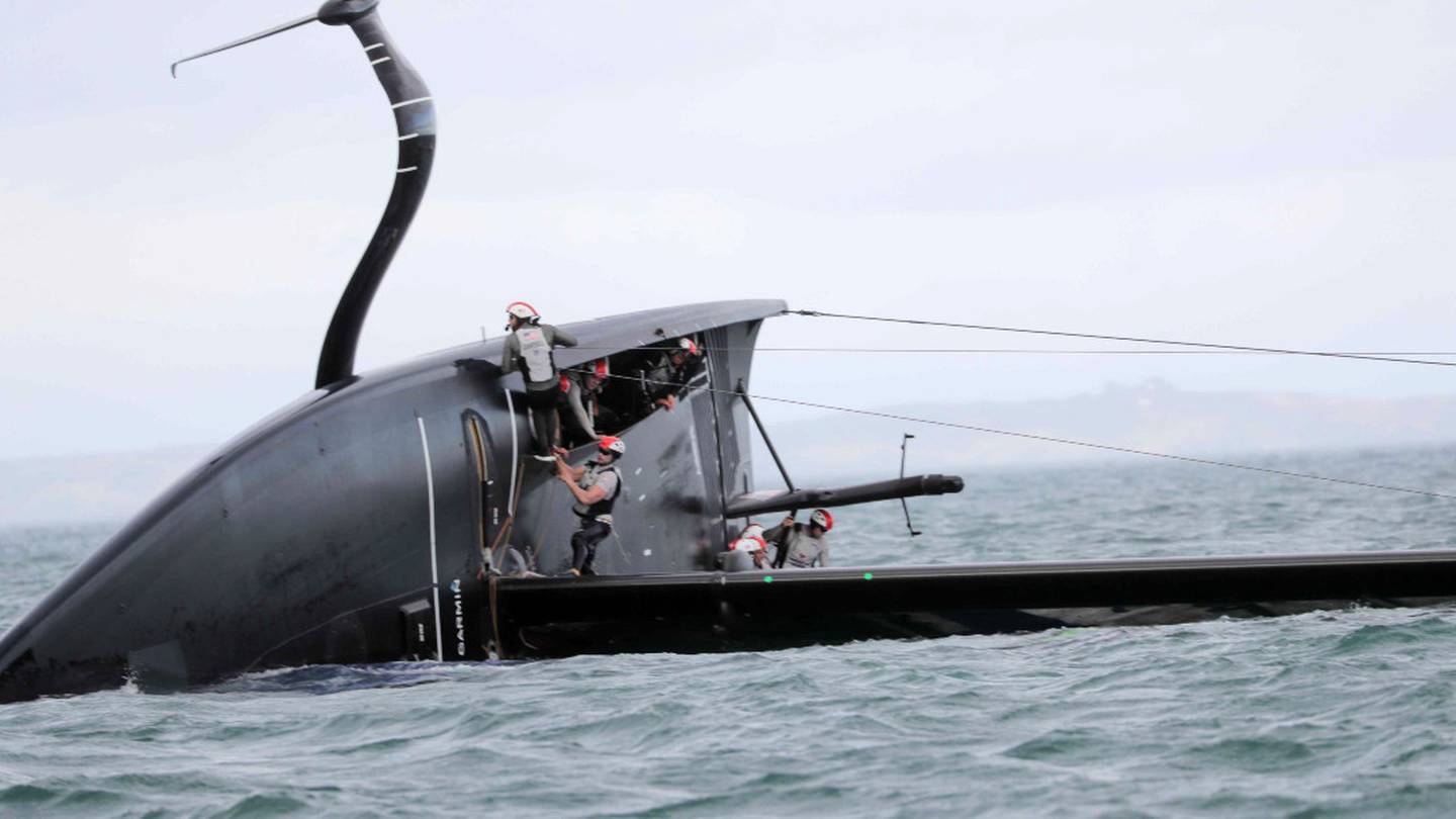 American Magic capsizes during their Day 3 race against Luna Rossa.
